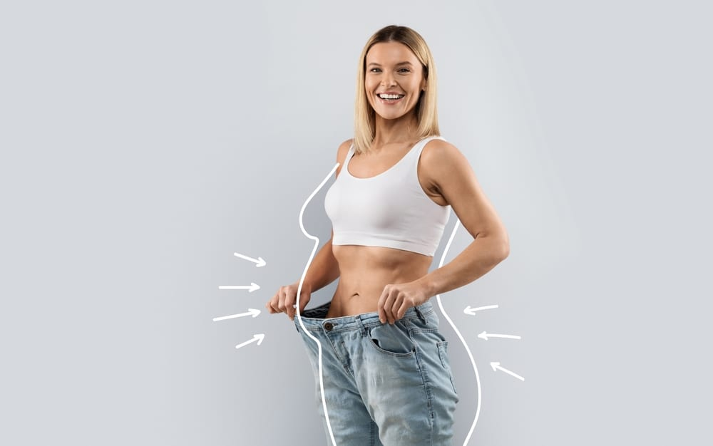 Woman measuring her waist with a tape measure