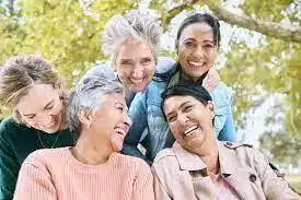 Group of women of different ages smiling together outdoors
