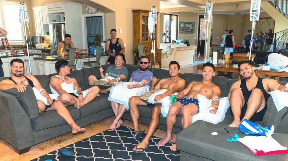 Group of people relaxing together indoors at a drip party event