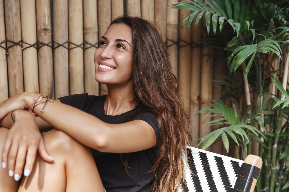 Woman sitting outdoors smiling
