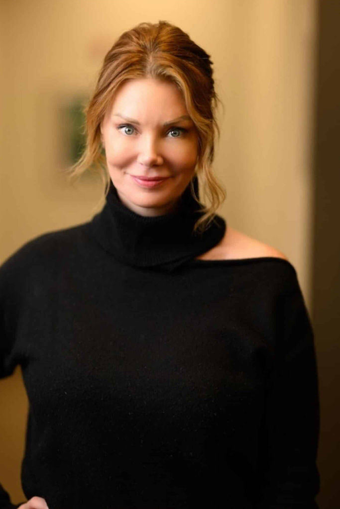 Woman with red hair wearing a black turtleneck