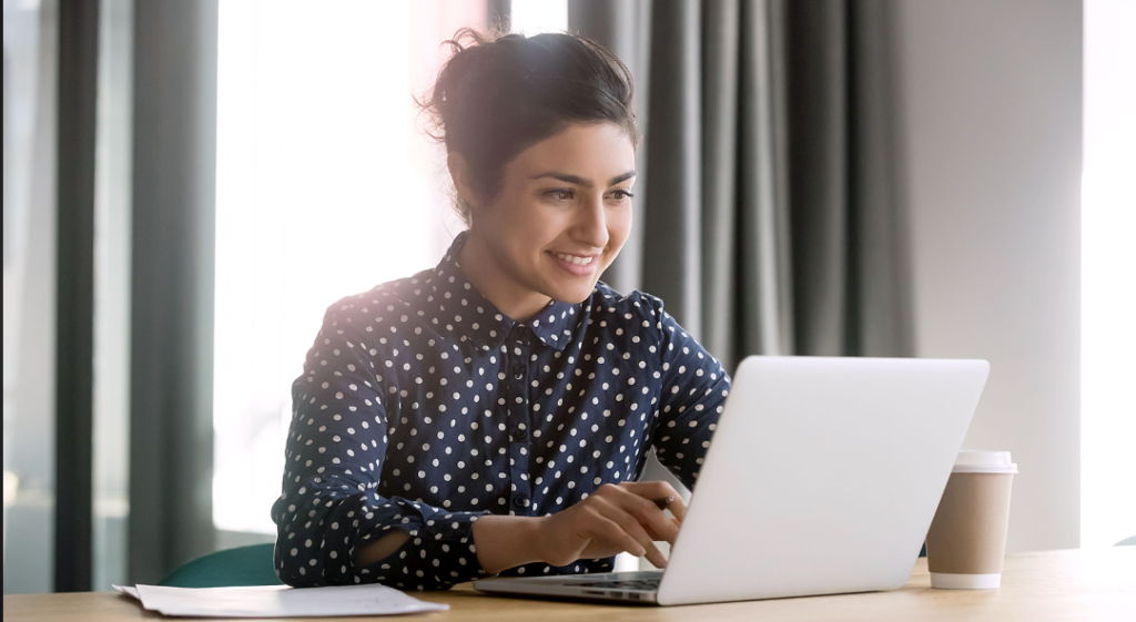 photo of woman at a desk using a laptop