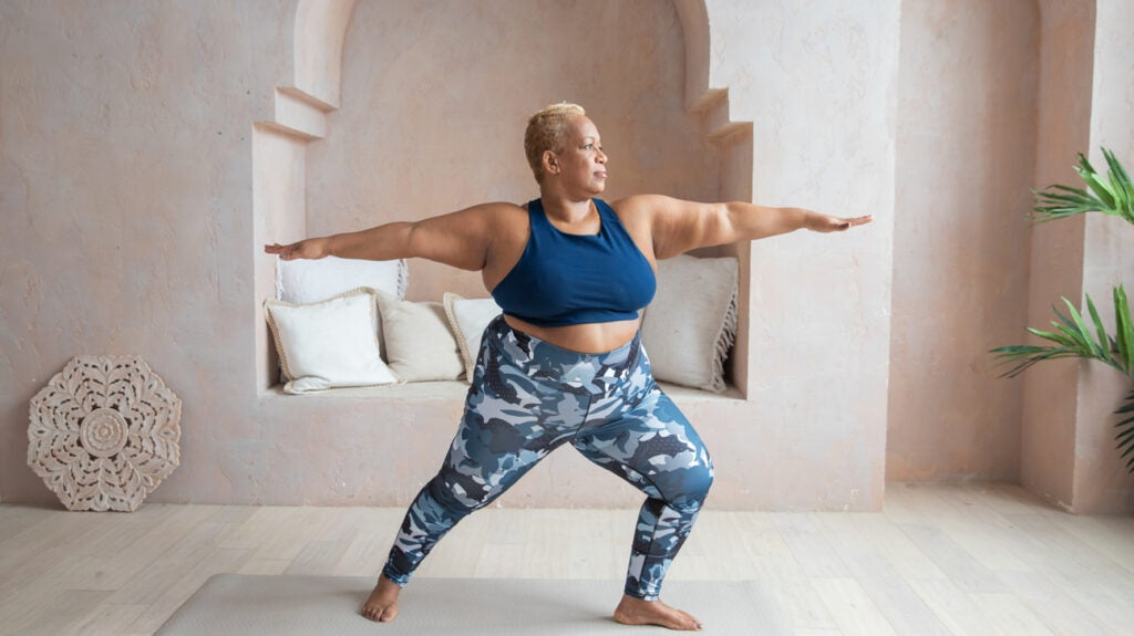 Woman doing a squat exercise with a resistance band