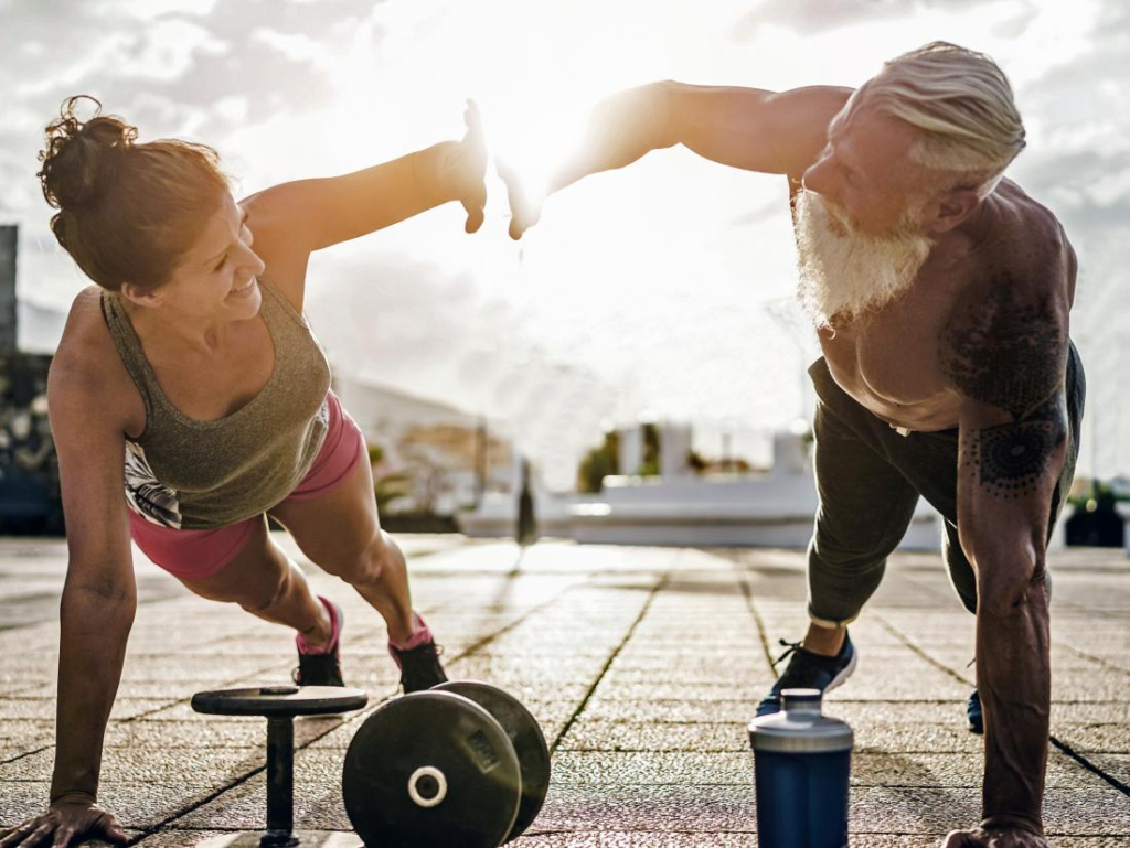 Two men doing an outdoor workout with a barbell