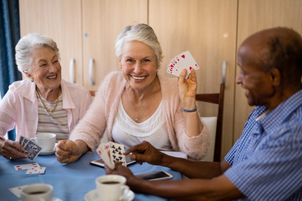 Group of older adults playing cards together