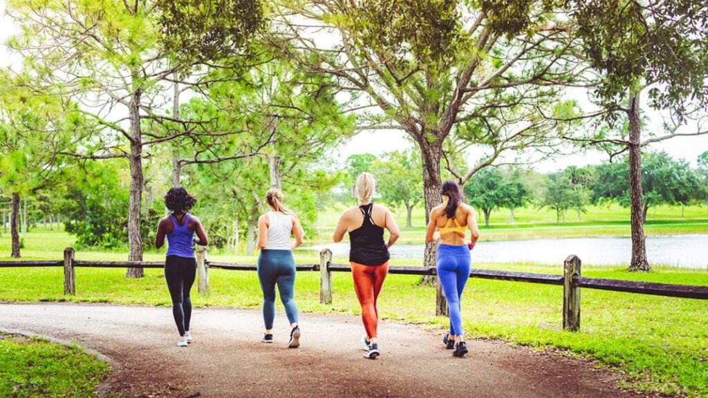 Group of people jogging together in a park