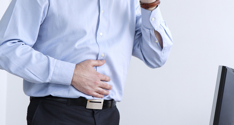 Person holding their stomach in discomfort