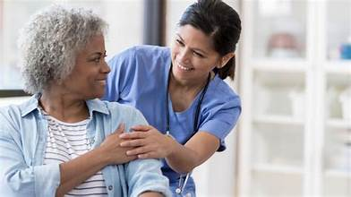 photo of a female nurse with and oler female patient