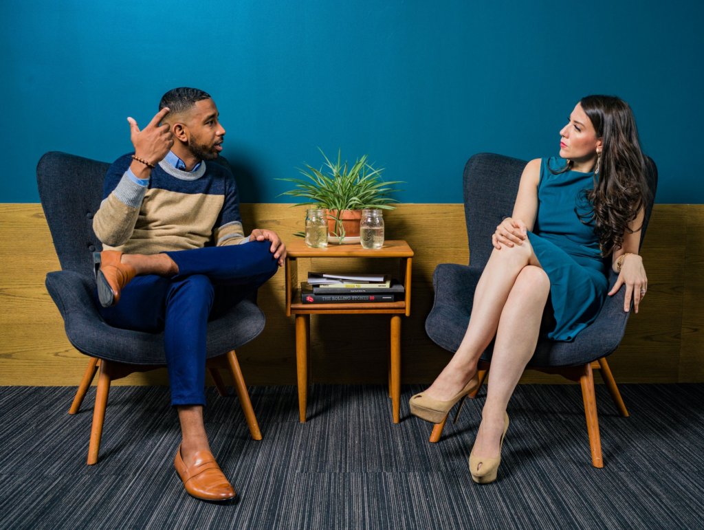 photo of a seated man and woman having a discussion