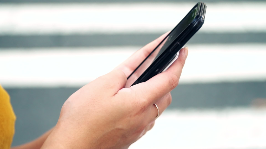closeup photo of a woman's hands holding a mobile phone